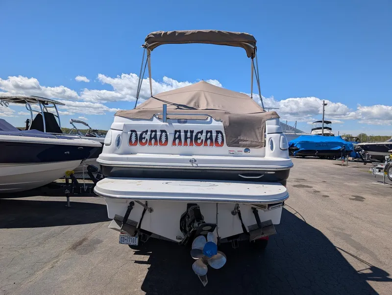 Slide: The Image of 2007 Larson Cabrio 240 boat parked on a lot. - 5