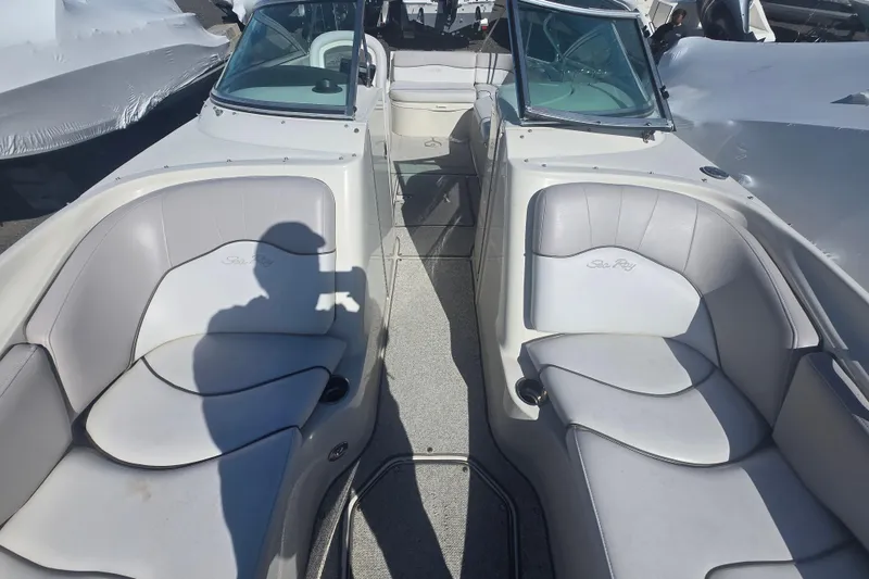 Slide: The Image of 2009 Sea Ray 240 Sundeck interior with dual seating and windshield, showcasing luxury design. - 11
