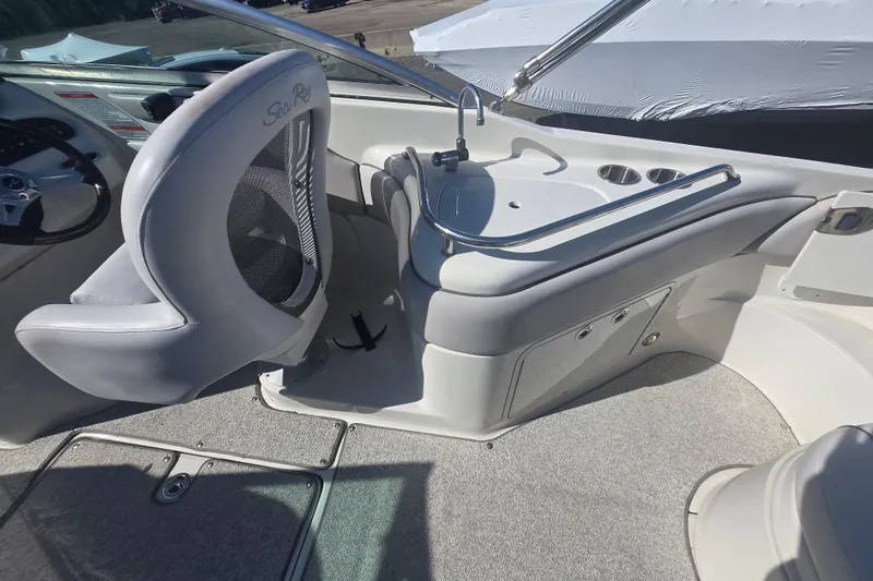 Slide: The Image of 2009 Sea Ray 240 Sundeck interior with helm seat and sink area. - 12