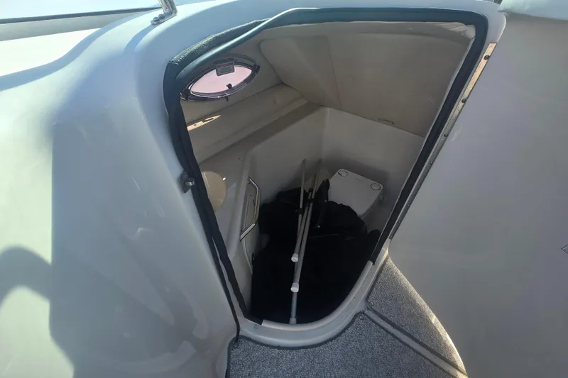 Slide: The Image of Interior storage compartment of 2009 Sea Ray 240 Sundeck boat with equipment. - 14