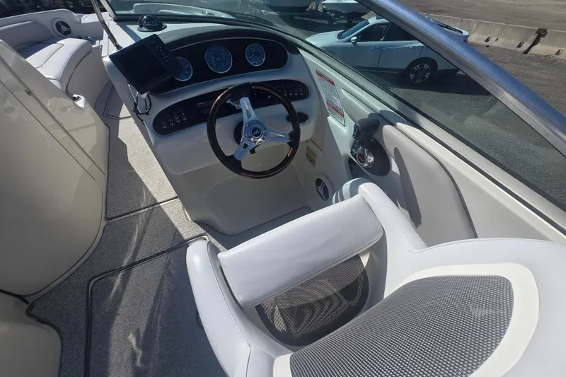 Slide: The Image of 2009 Sea Ray 240 Sundeck boat interior with steering wheel and dashboard controls. - 4