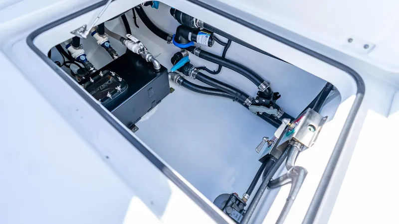 Slide: The Image of Freeman 35 boat engine compartment with hoses and valves, year 2025. - 13