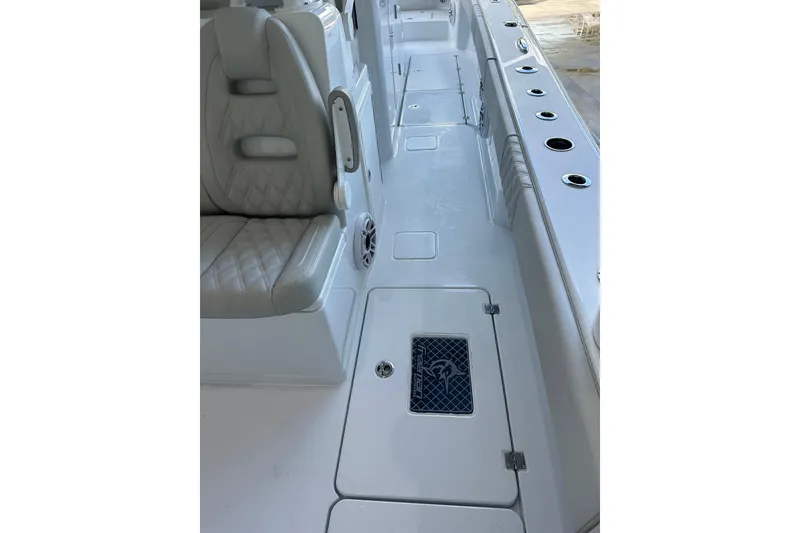 Slide: The Image of Interior view of a 2025 Freeman 35 boat, featuring cushioned seating and storage compartments. - 7