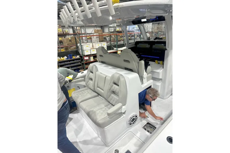 Slide: The Image of 2025 Freeman 35 boat interior with cushioned seating and control panel in a workshop setting. - 8