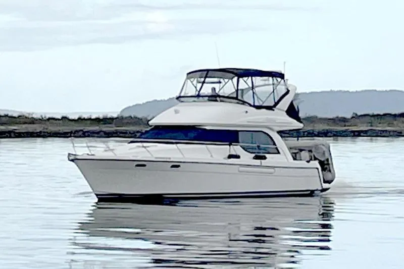 The Image of 2001 Bayliner 3788 Command Bridge Motoryacht cruising on calm waters. - 0