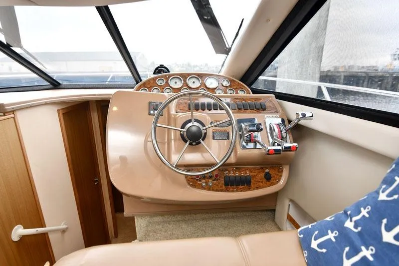 Slide: The Image of 2001 Bayliner 3788 Command Bridge Motoryacht helm with steering wheel and control panel. - 10