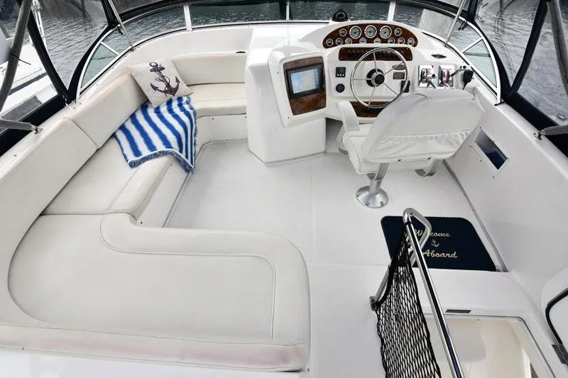 Slide: The Image of 2001 Bayliner 3788 Command Bridge Motoryacht interior with helm, seating, and nautical decor. - 16