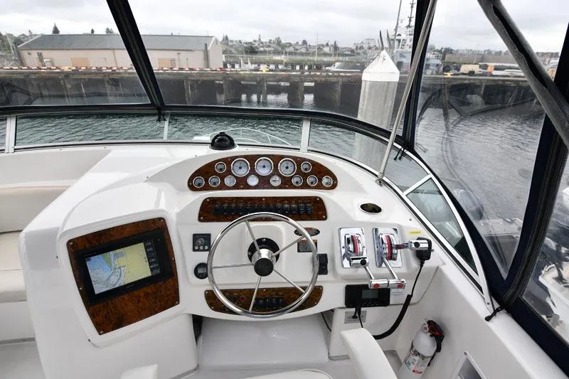 Slide: The Image of 2001 Bayliner 3788 Command Bridge Motoryacht helm with navigation controls and gauges. - 17