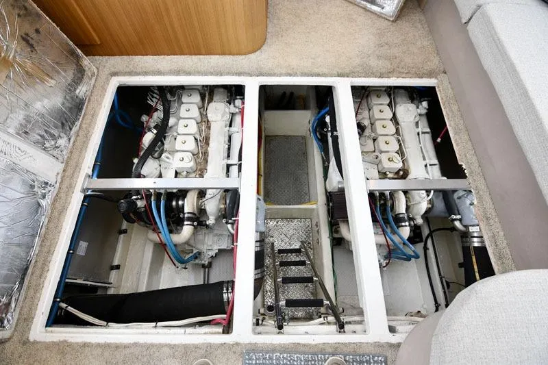Slide: The Image of Engine room of 2001 Bayliner 3788 Command Bridge Motoryacht, showcasing dual engines and mechanical components. - 20