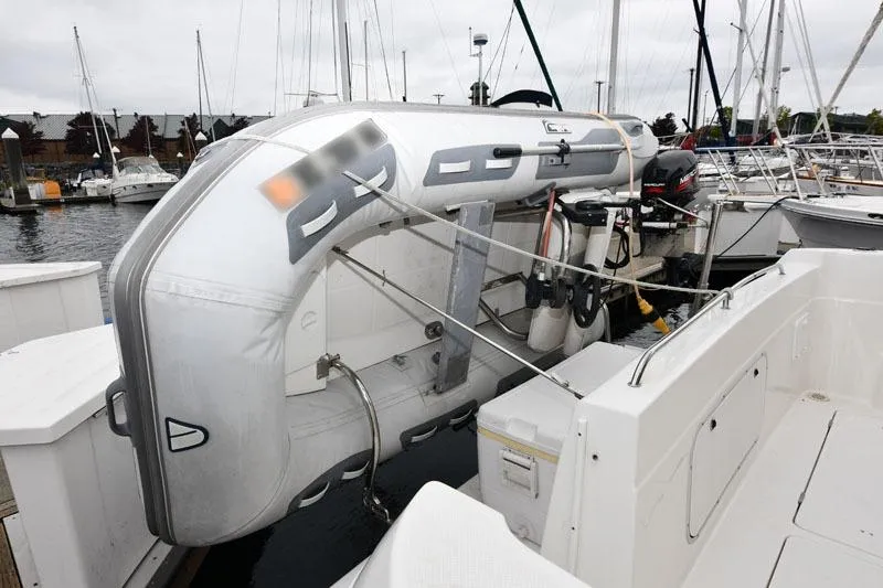 Slide: The Image of 2001 Bayliner 3788 Command Bridge Motoryacht with inflatable dinghy at marina. - 3