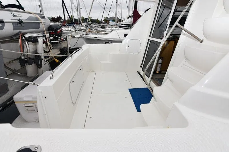 Slide: The Image of 2001 Bayliner 3788 Command Bridge Motoryacht deck with steps and marina view. - 4