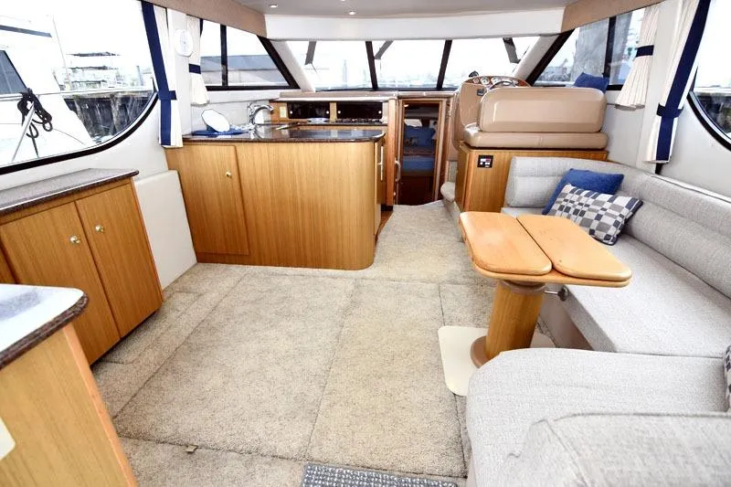 Slide: The Image of Interior of 2001 Bayliner 3788 Command Bridge Motoryacht with cozy seating and wooden cabinetry. - 6