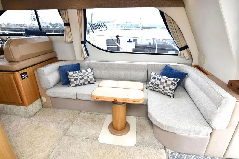 Slide: The Image of Interior of 2001 Bayliner 3788 Command Bridge Motoryacht with cozy seating and table. - 7