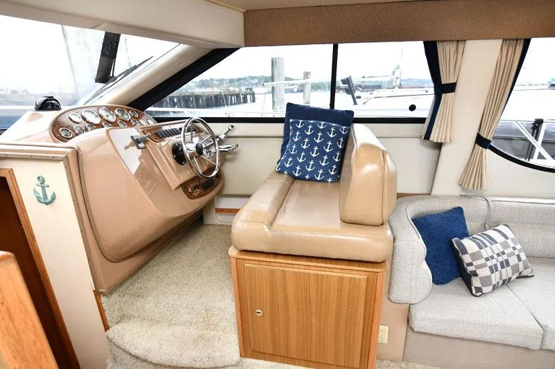 Slide: The Image of 2001 Bayliner 3788 Command Bridge Motoryacht interior with helm, seating, and nautical decor. - 9