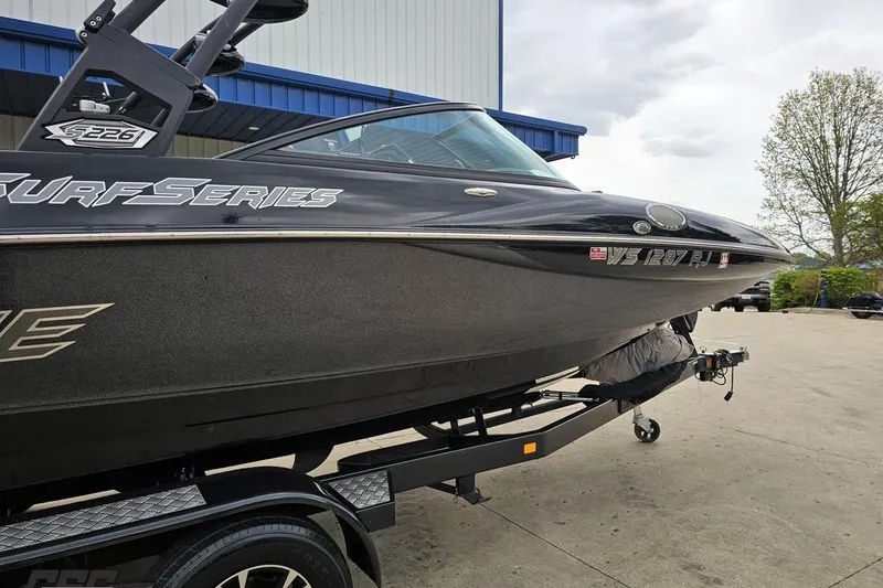 Slide: The Image of 2018 Supreme S226 Surf Series boat on trailer, parked outdoors. - 10