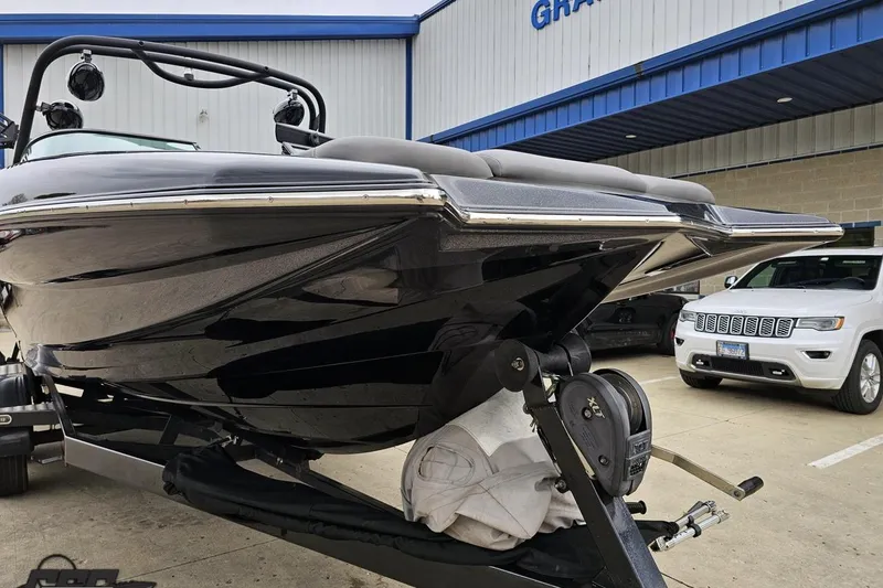 Slide: The Image of 2018 Supreme S226 boat on trailer, parked outside dealership. - 16