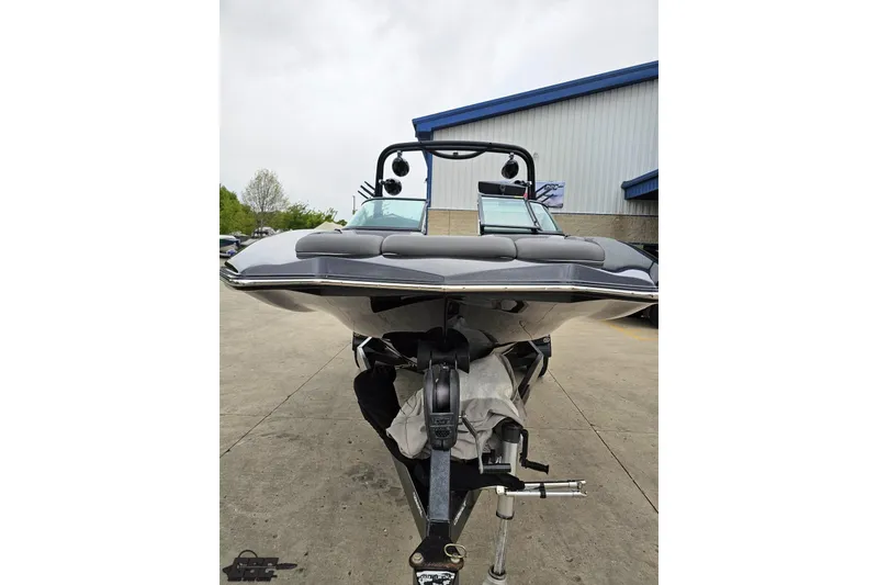 Slide: The Image of 2018 Supreme S226 boat on trailer, parked outside a building. - 17