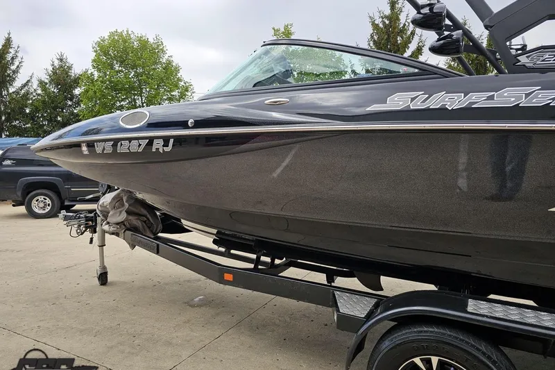 Slide: The Image of 2018 Supreme S226 boat on trailer, black exterior, parked outdoors. - 25