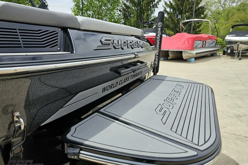 Slide: The Image of 2018 Supreme S226 boat with "World Class Towboats" branding, docked outdoors. - 32