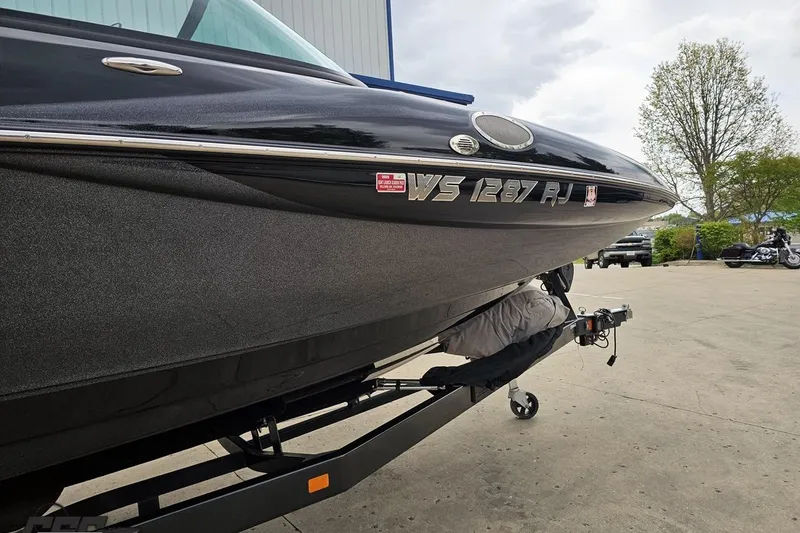 Slide: The Image of 2018 Supreme S226 boat on trailer, parked outdoors. - 4