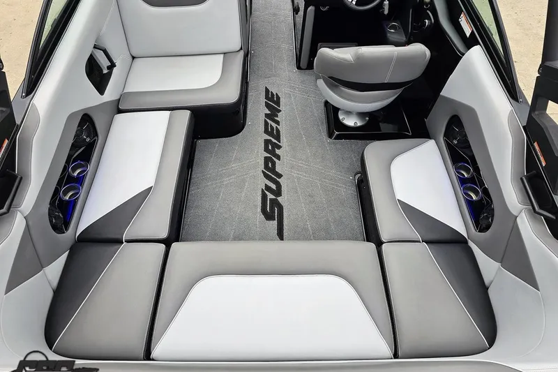 Slide: The Image of 2018 Supreme S226 boat interior with gray and white seating, featuring cup holders. - 43