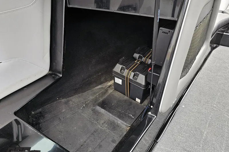 Slide: The Image of Storage compartment of a 2018 Supreme S226 boat with battery boxes. - 58