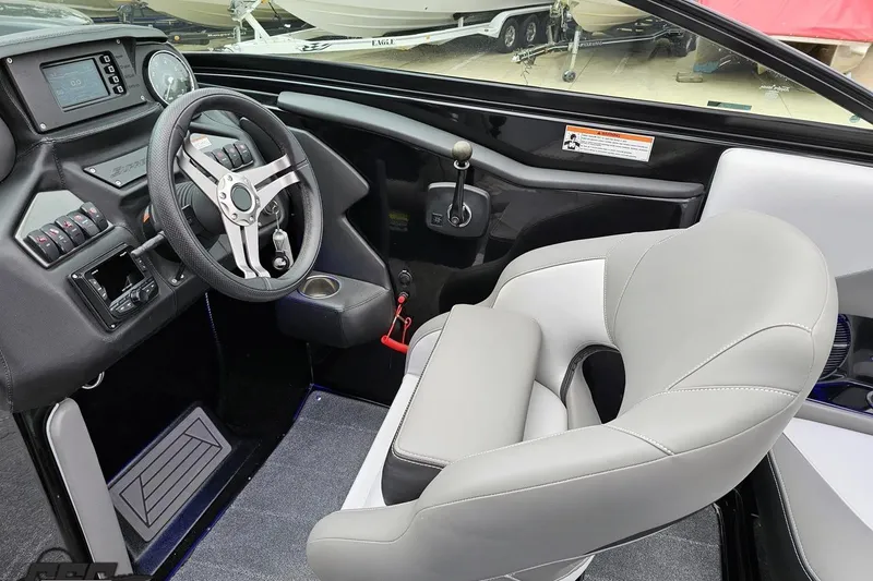 Slide: The Image of 2018 Supreme S226 boat interior with steering wheel, dashboard, and comfortable seating. - 62