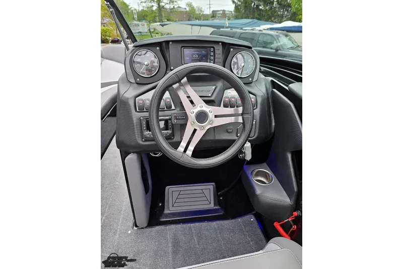 Slide: The Image of Cockpit of 2018 Supreme S226 boat with steering wheel and control panel. - 64