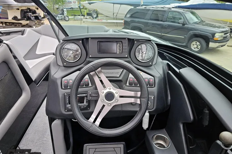 Slide: The Image of Cockpit of 2018 Supreme S226 boat with steering wheel and dashboard controls. - 65