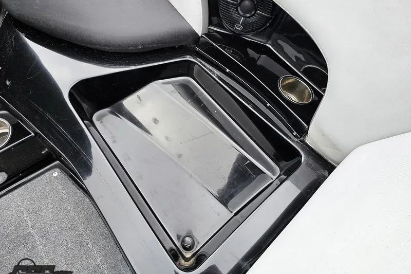 Slide: The Image of 2018 Supreme S226 boat interior storage compartment with cup holder and speaker. - 79