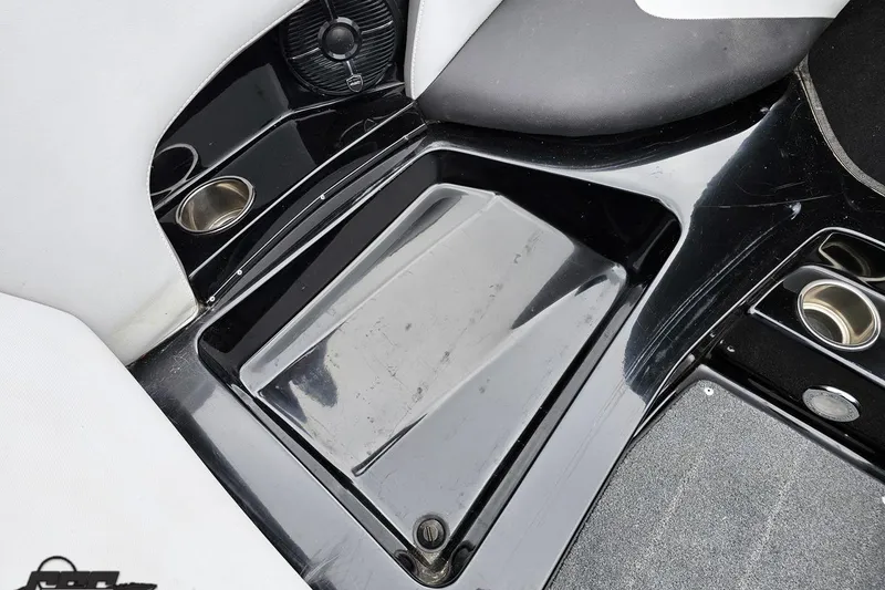 Slide: The Image of Interior of a 2018 Supreme S226 boat, featuring cup holders and sleek black design. - 80