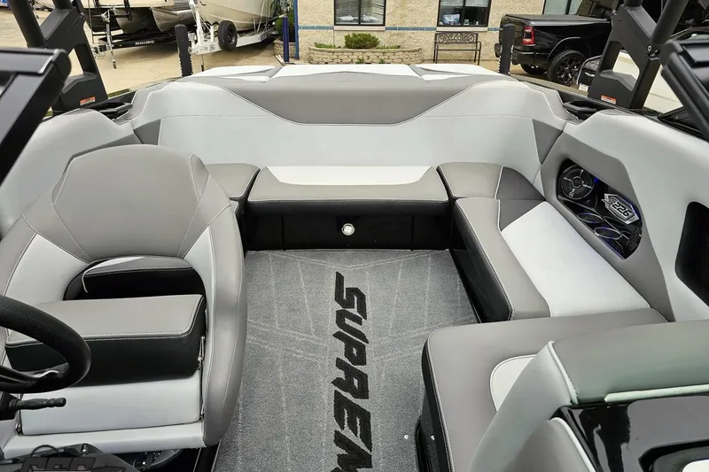 Slide: The Image of Interior of a 2018 Supreme S226 boat with gray seating and branded carpet. - 86