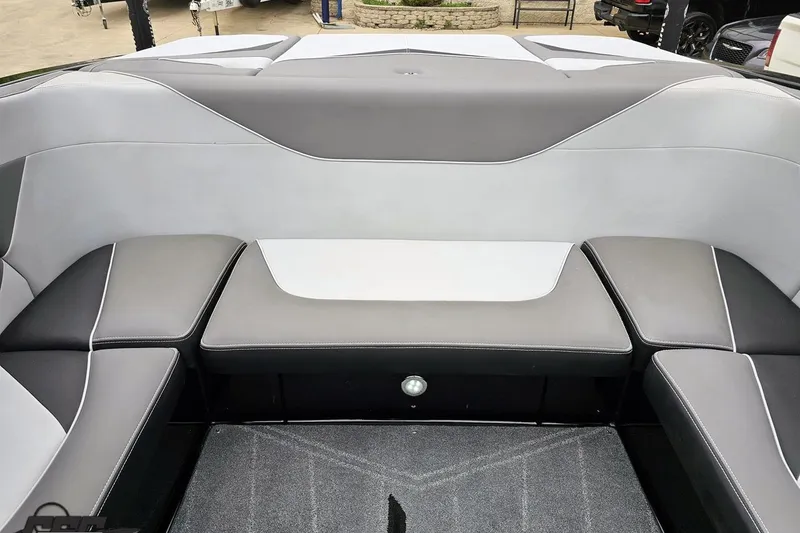 Slide: The Image of Interior seating of a 2018 Supreme S226 boat, featuring gray and white upholstery. - 89
