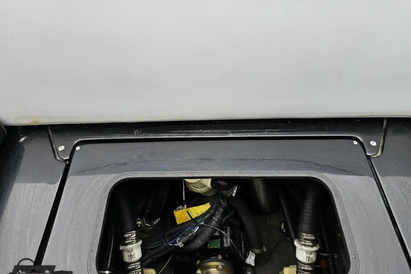 Slide: The Image of Engine compartment of a 2018 Supreme S226 boat, showcasing mechanical components. - 92
