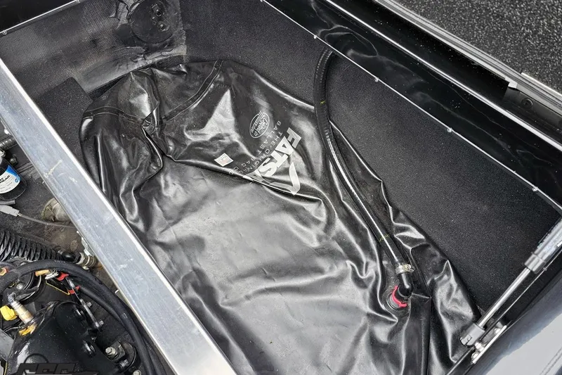Slide: The Image of 2018 Supreme S226 ballast bag in boat compartment, featuring hoses and fittings. - 97