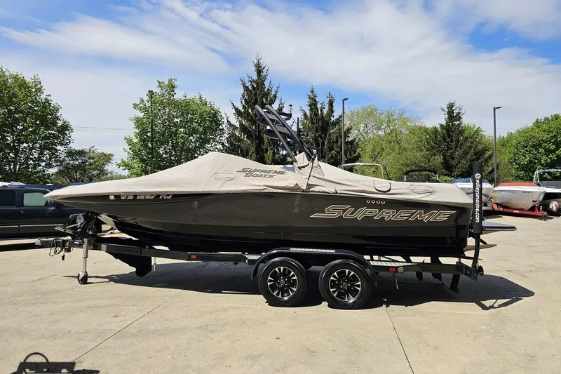 Slide: The Image of 2018 Supreme S226 boat on trailer, covered, parked outdoors. - 99
