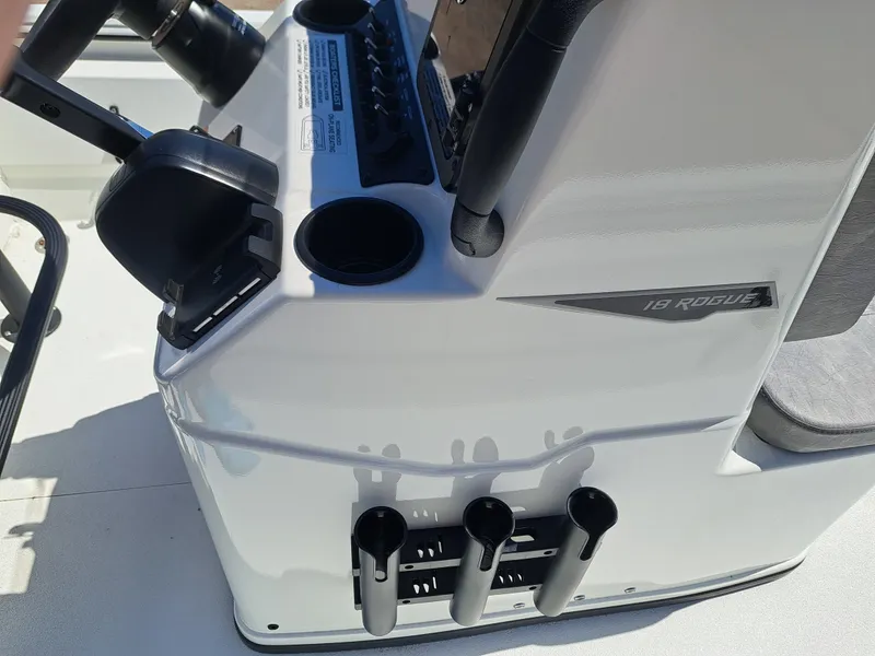 Slide: The Image of Avid 18CC ROGUE 2026 boat console with cup holders and controls. - 14
