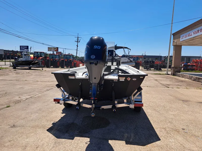 Slide: The Image of Avid 18CC ROGUE 2026 boat with outboard motor in parking lot. - 7