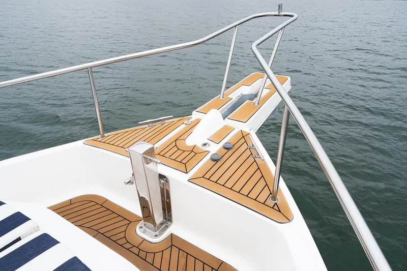 Slide: The Image of Bow of 2011 Mainship 395 Trawler with teak decking on calm water. - 20