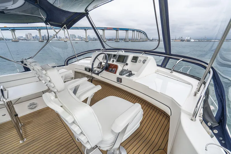 Slide: The Image of Helm of 2011 Mainship 395 Trawler with cityscape and bridge in background. - 24