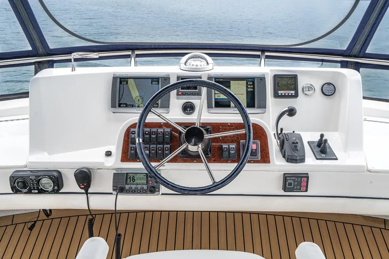 Slide: The Image of Cockpit of 2011 Mainship 395 Trawler with navigation instruments and steering wheel. - 25