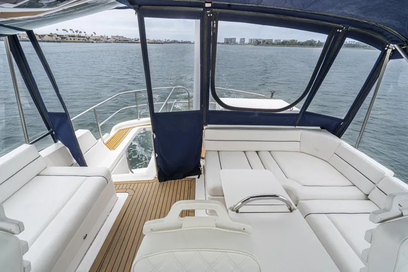 Slide: The Image of 2011 Mainship 395 Trawler interior with white seating and ocean view. - 26