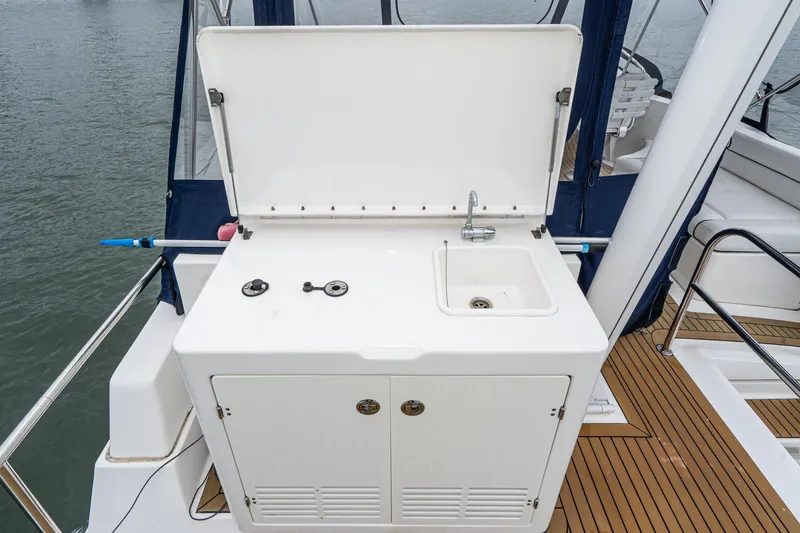 Slide: The Image of Outdoor sink and storage on 2011 Mainship 395 Trawler boat deck. - 29