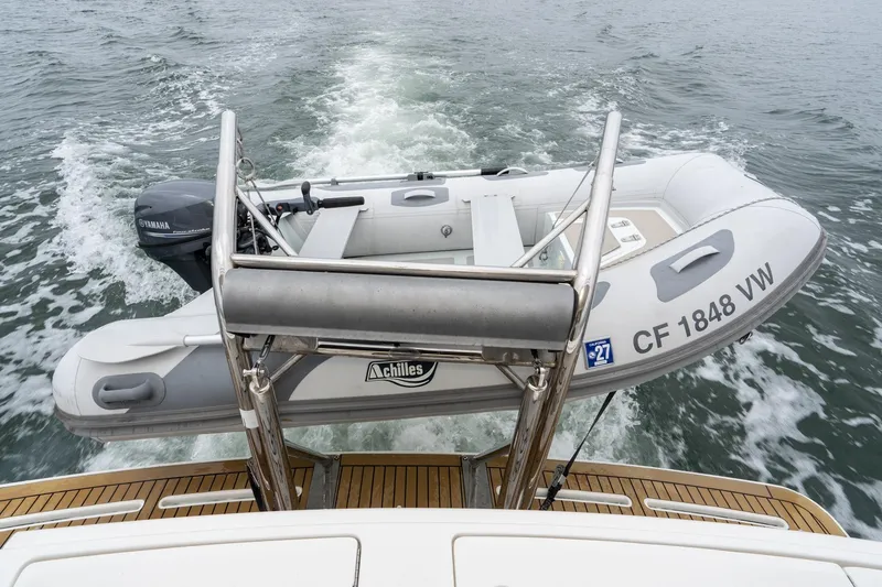 Slide: The Image of 2011 Mainship 395 Trawler with Achilles dinghy and Yamaha motor on water. - 32