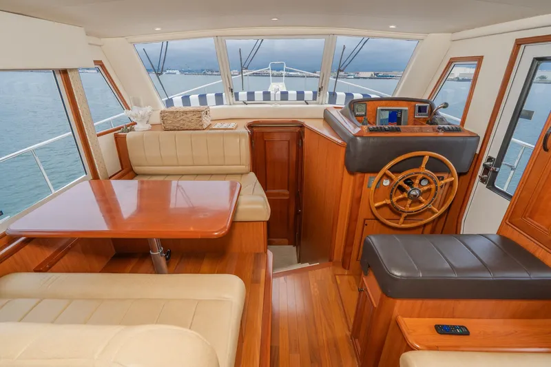 Slide: The Image of Interior of 2011 Mainship 395 Trawler with wood finish and leather seating. - 4