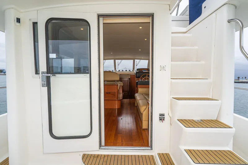 Slide: The Image of 2011 Mainship 395 Trawler interior view with open door and staircase. - 40