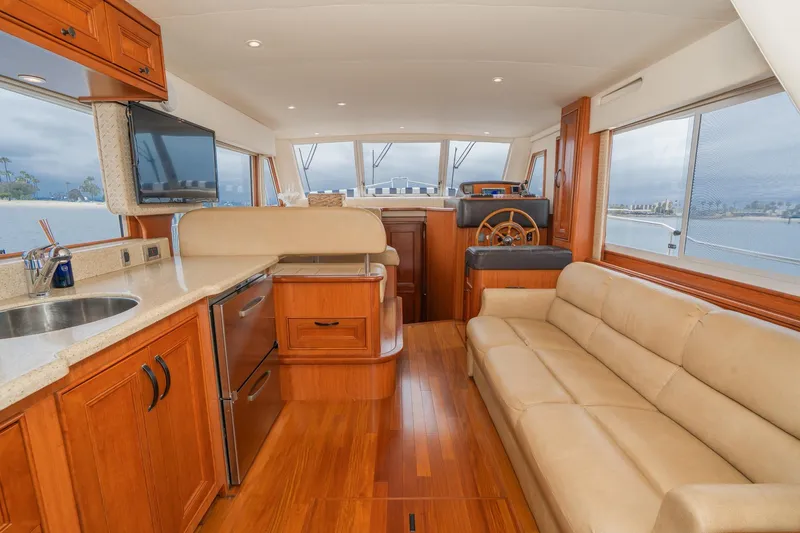 Slide: The Image of Luxurious interior of 2011 Mainship 395 Trawler with leather seating and wooden cabinetry. - 41