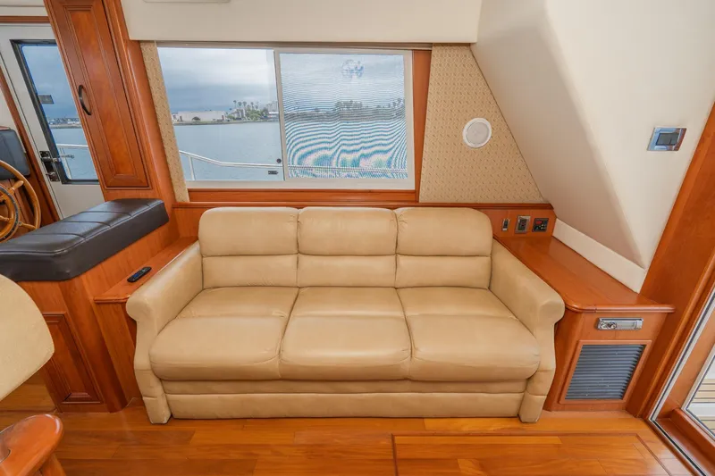 Slide: The Image of Interior of 2011 Mainship 395 Trawler with beige sofa and wooden accents. - 42