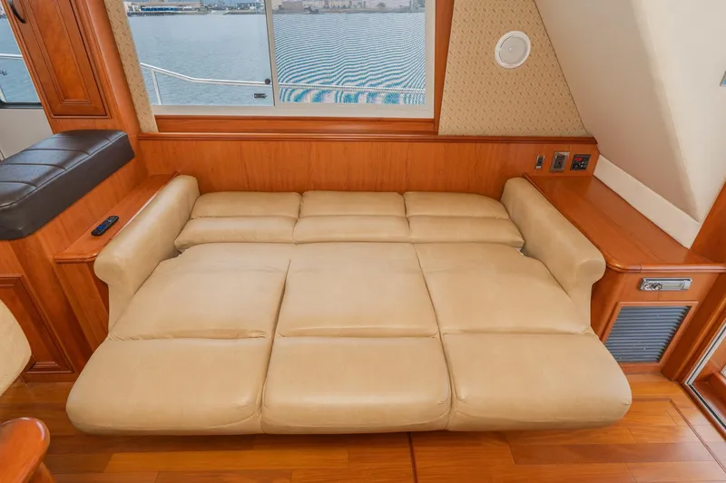 Slide: The Image of Luxurious beige leather seating in 2011 Mainship 395 Trawler interior, with scenic window view. - 43