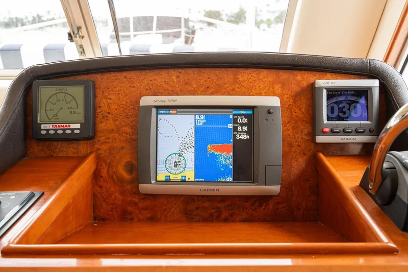 Slide: The Image of Mainship 395 Trawler 2011 dashboard with Garmin navigation and Yanmar engine displays. - 50